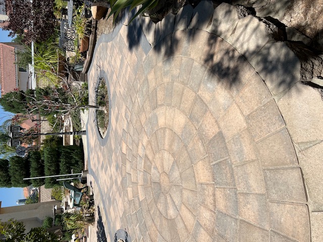 Stacked stone retaining wall by Pave It Landscape LLC