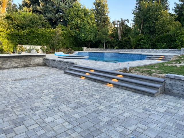 Circular paver driveway by Pave It Landscape LLC